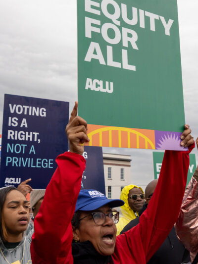 A group of voting rights advocates marching over the Edmund Pettus Bridge.