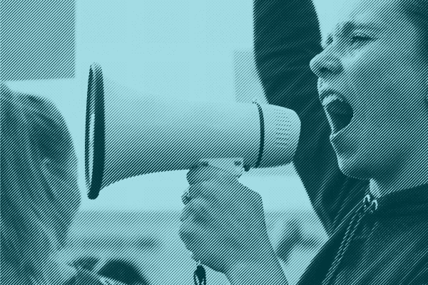 Person facing crowd with a microphone.