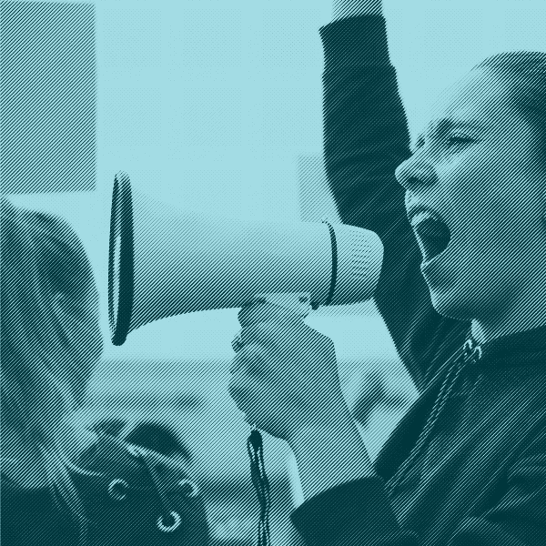 Person facing crowd with a microphone.