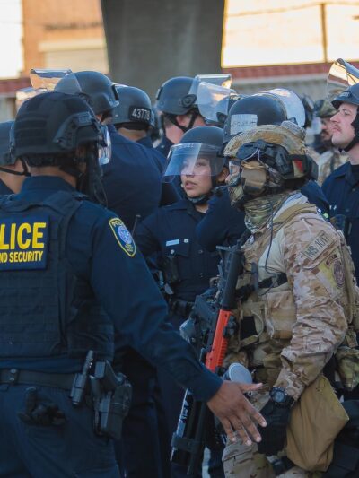 Border Patrol agents and police congregating during during a demonstration against expanded ICE operations and in support of immigrant rights.