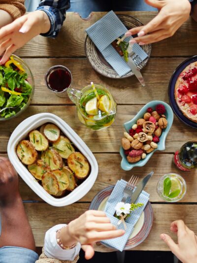 A group of people have an animated conversation over a dinner table.