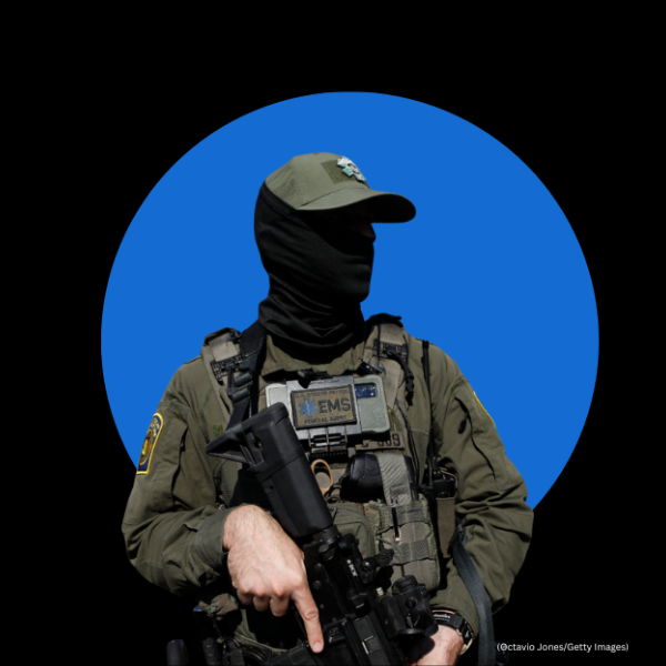 Image of a police officer wearing a black mask covering all of their face.