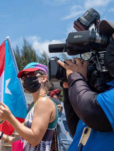 A individual filming a protest in Rincon, Puerto Rico.
