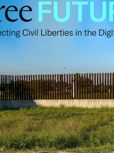 A drone hovering low as a man in camouflage military clothing watches