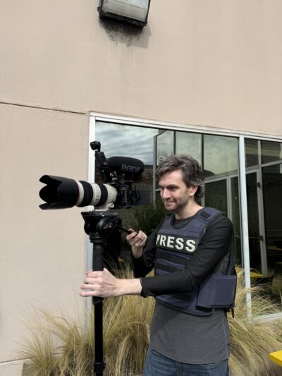 Mason with his press vest and video camera