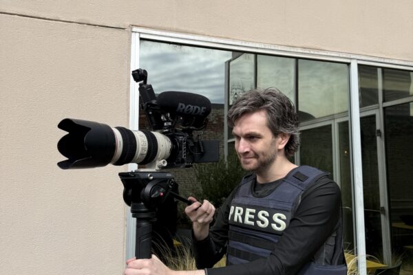 Mason with his press vest and video camera