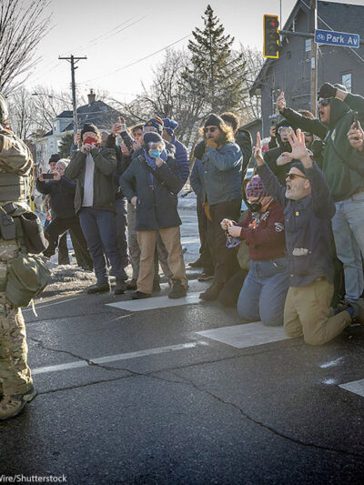 A photos of demonstrators in Minneapolis filming federal agents.