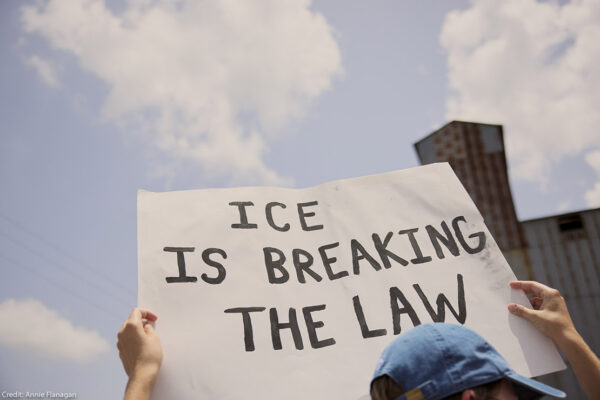 A demonstrator at the Journey to Justice rally in Basile, Louisiana on June 30, 2025 holding a sign that says, "ICE is Breaking The Law."