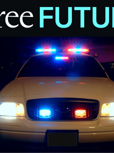 A frontal view of a police car with its lights on at night