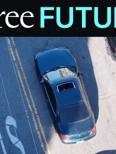 Aerial drone photo of a car with sunroof driving down street
