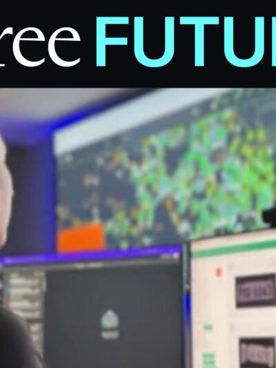 A police officer looking at data screens at front of a dark command center