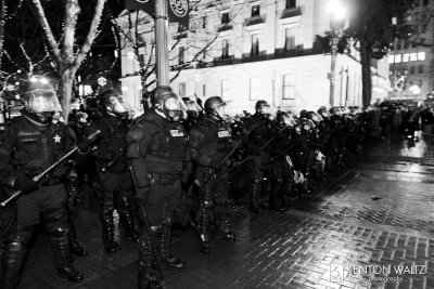 A line of police in riot gear