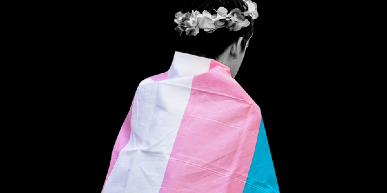 youth wearing a transgender flag