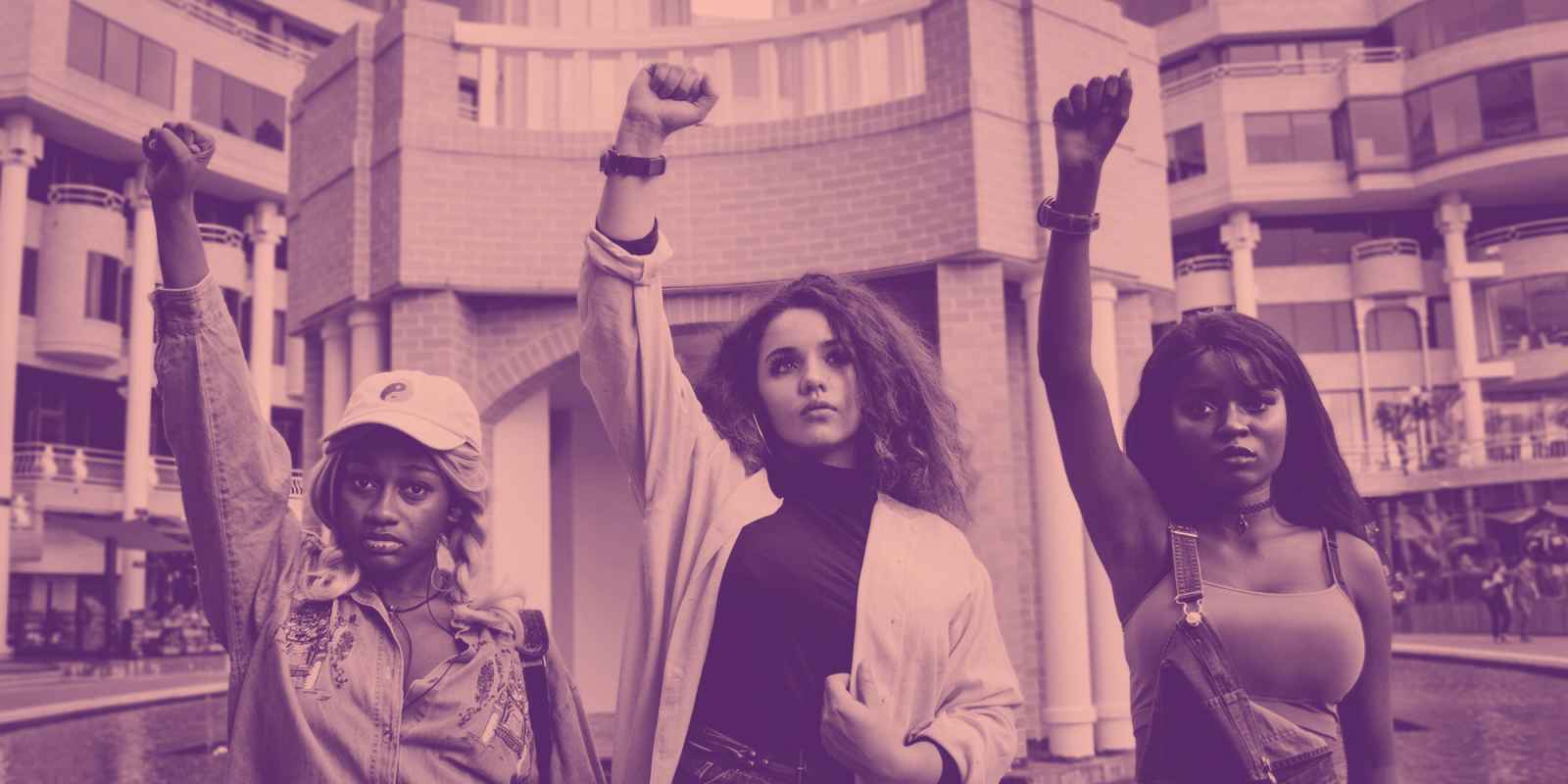 people in protest raising fists on pink background