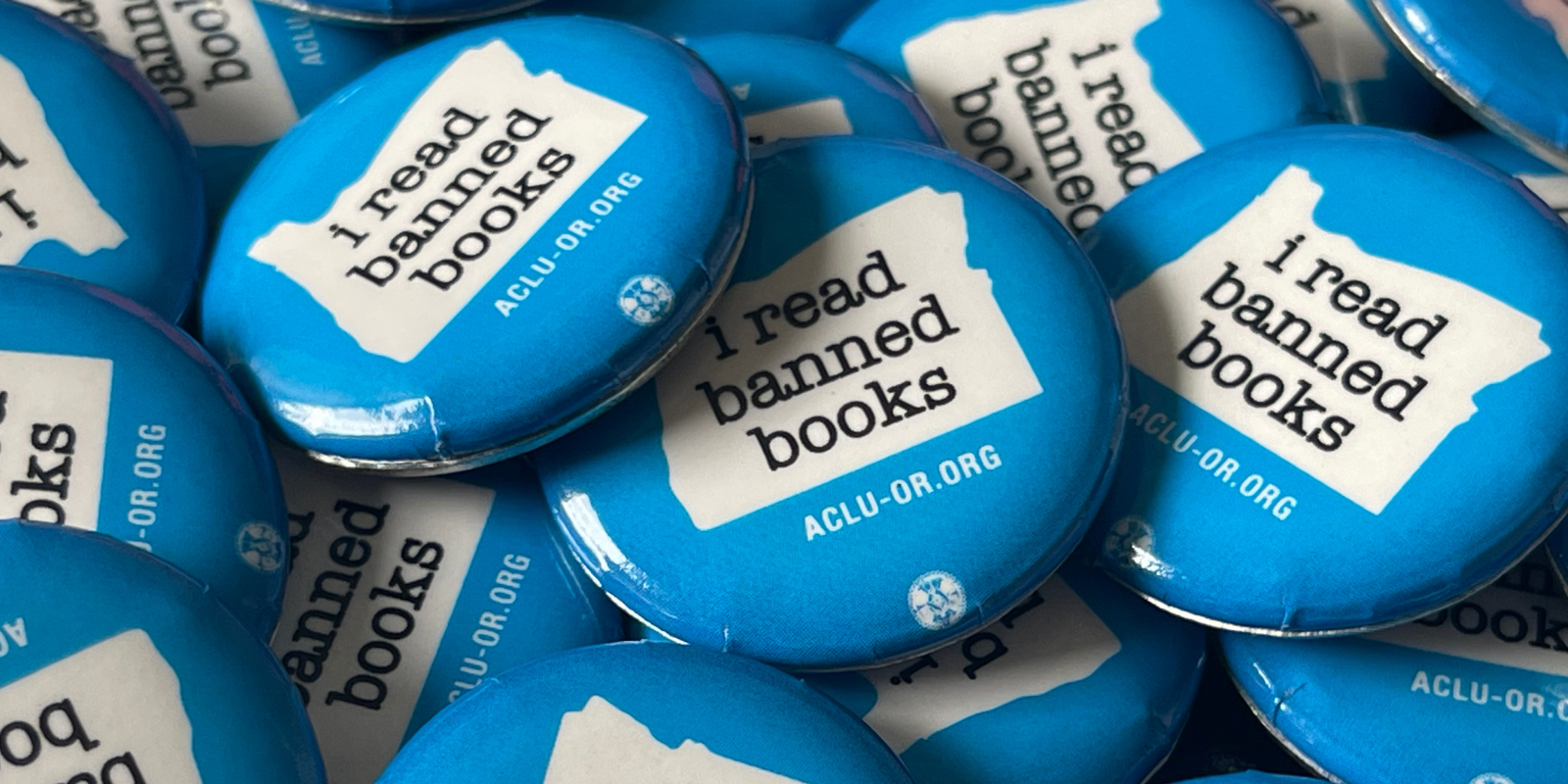 A pile of blue "I read banned books" pins 