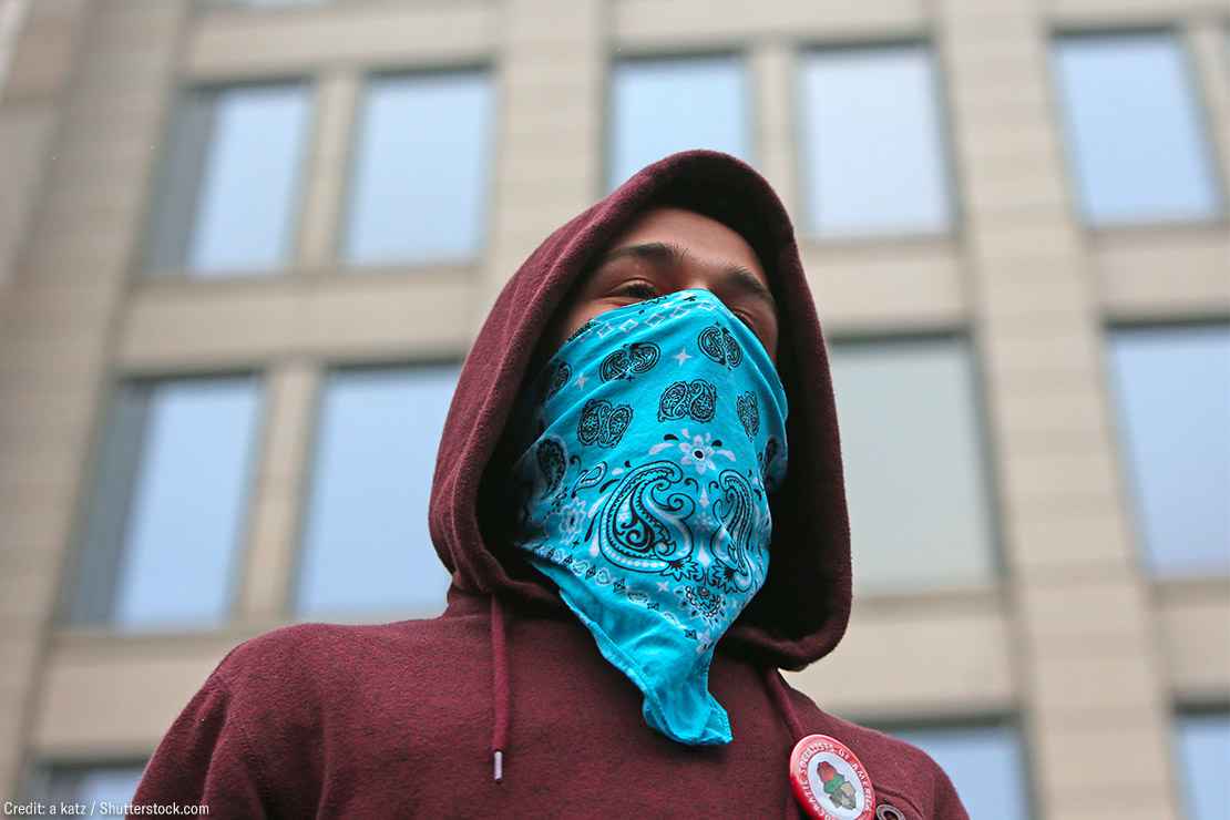 A demonstrator wearing a bandana on their face