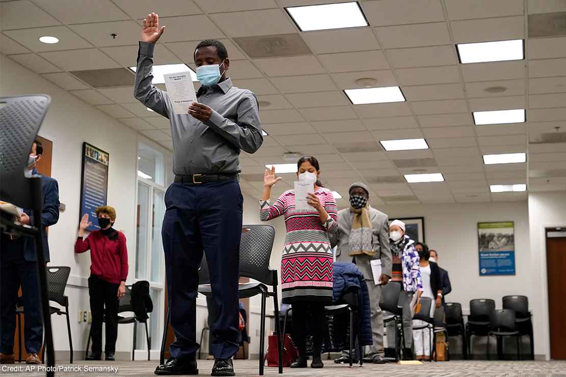 Candidates for American citizenship recite the Oath of Allegiance during a naturalization ceremony.