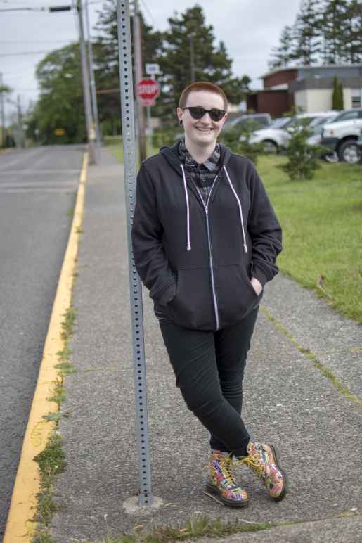 Hailey leans against a street sign 