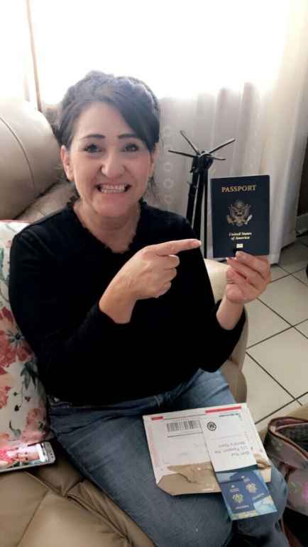 Maria Soto holds her passport and points to it