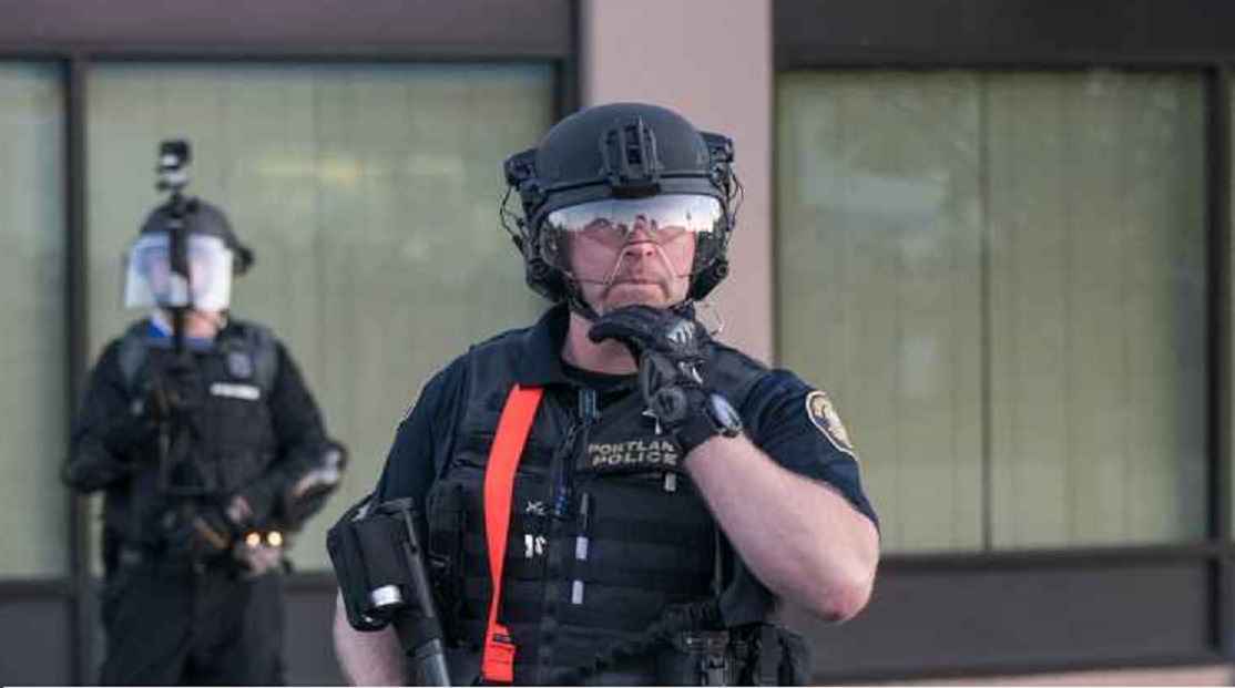 Photo of Portland police officer livestreaming protest