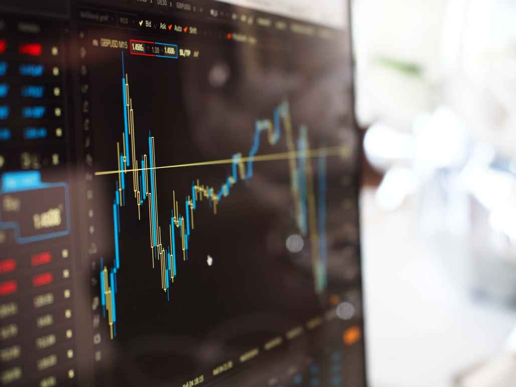 A blue and yellow graph depict the stock market on a computer screen