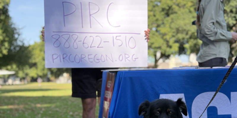 Dog in front of PIRC sign