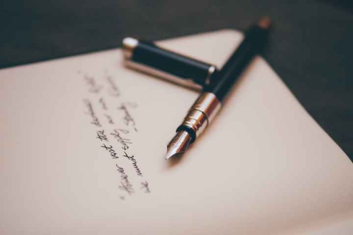 Photo by Alvaro Serrano A fountain pen lies on a handwritten note