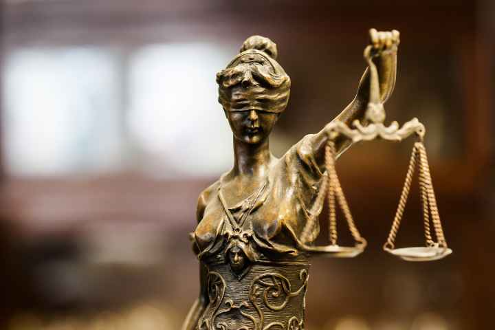 statue of blindfolded woman holding scales of justice