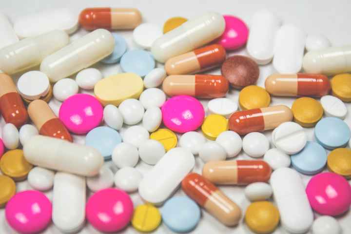 A jumble of pills of various shapes, sizes, and colors