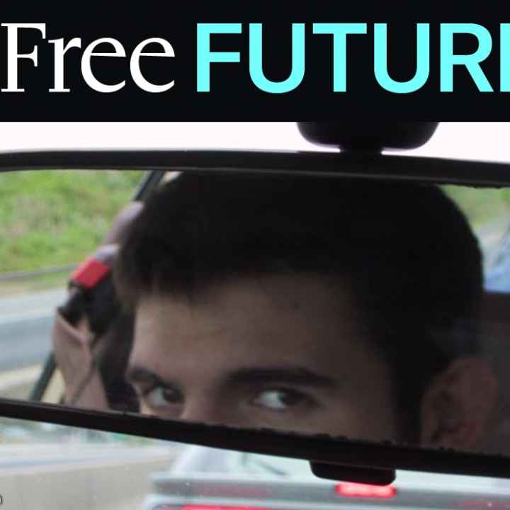 Man looking in car rear-view mirror, warily
