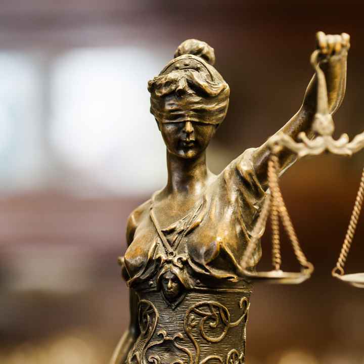 statue of blindfolded woman holding scales of justice