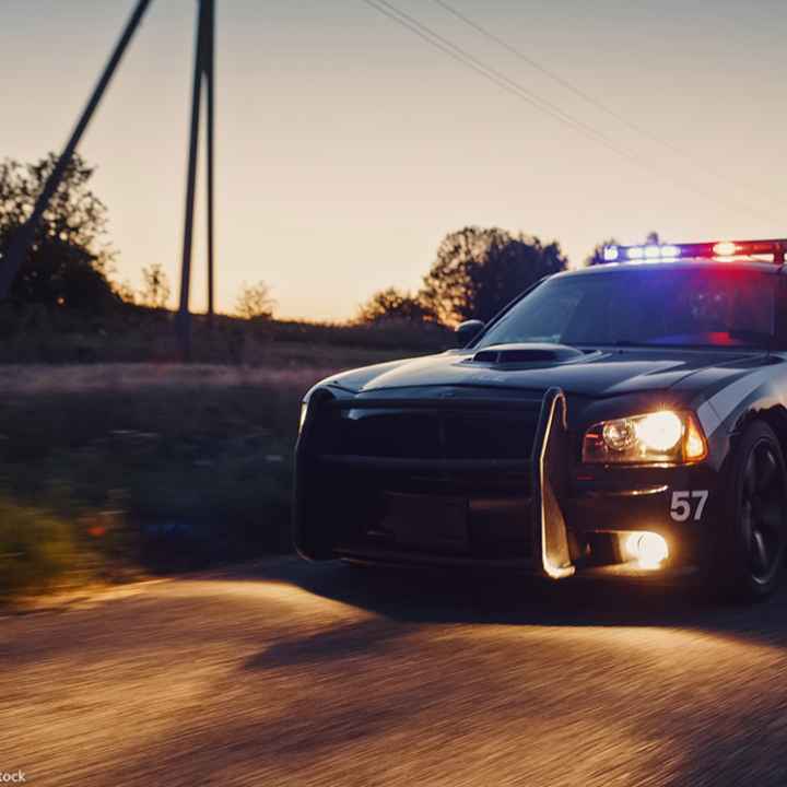 A police crd speeding down the road.