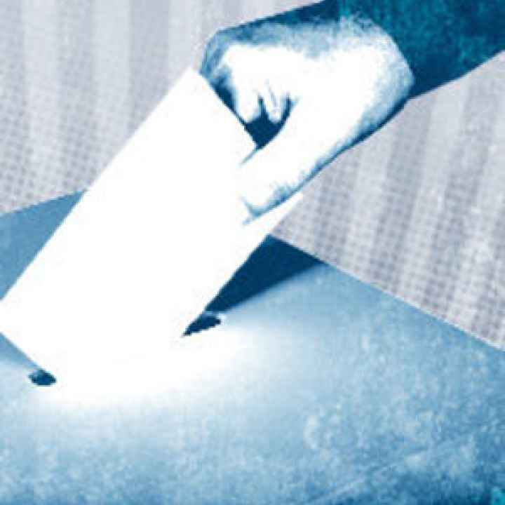 hand dropping ballot in box