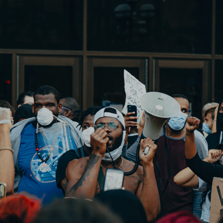groups of protesters in front of glass doors. 