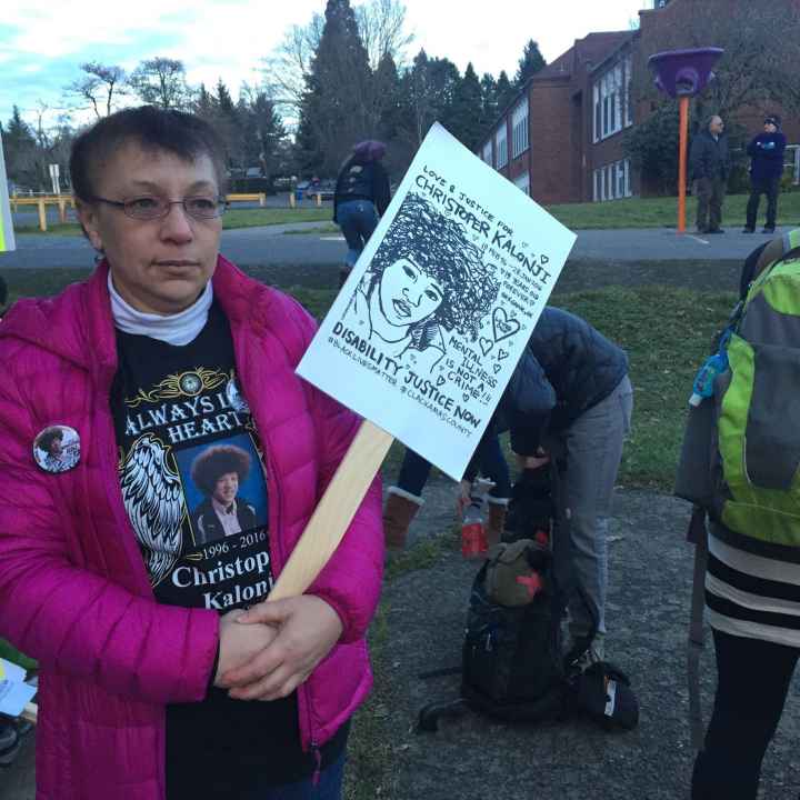 Irene Kalonji Irene Kalonji holds a sign with her son's face on it at a memorial event
