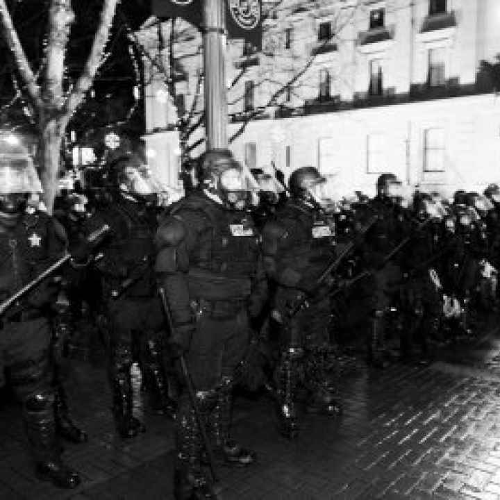 A line of police in riot gear
