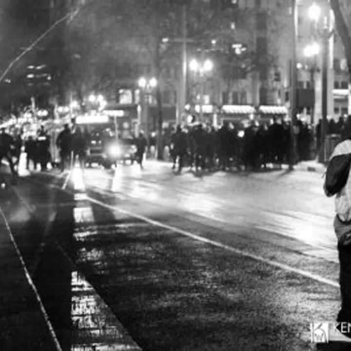 protester and police protester faces off with police