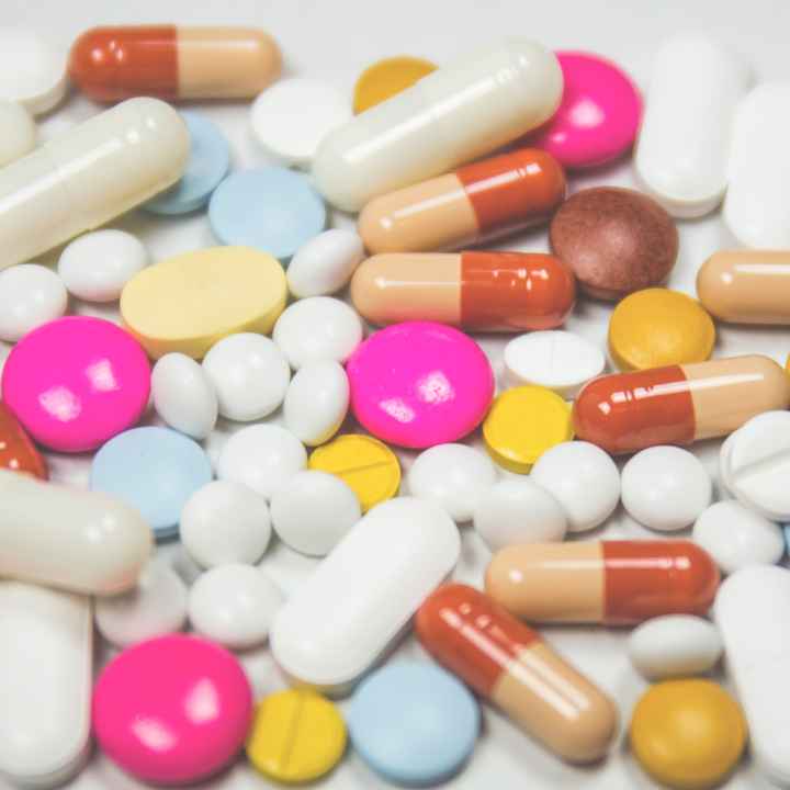 A jumble of pills of various shapes, sizes, and colors