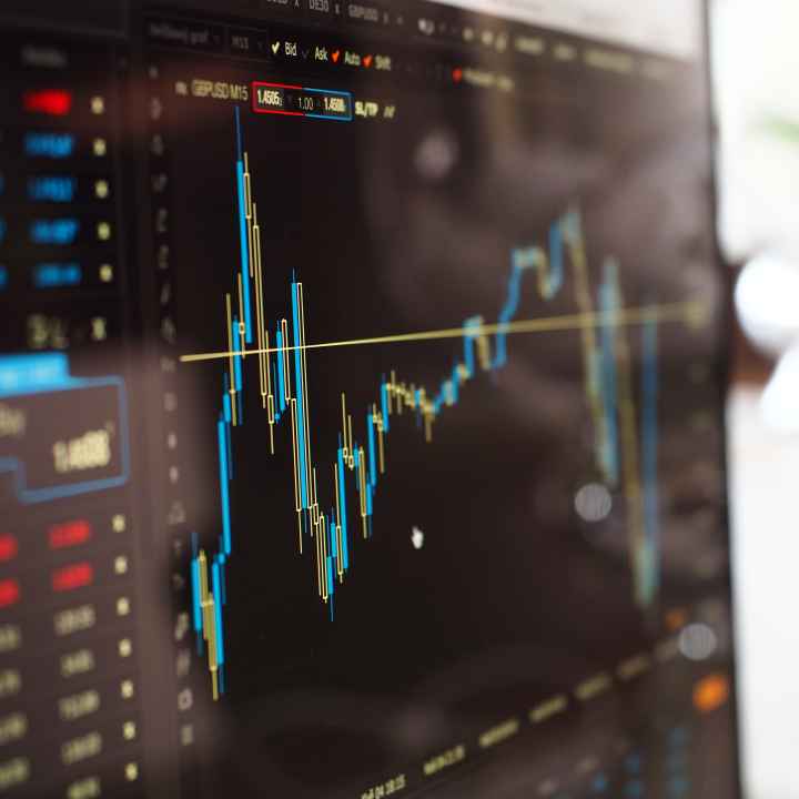 A blue and yellow graph depict the stock market on a computer screen
