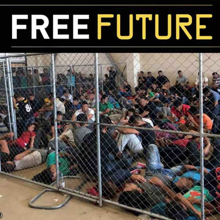 Immigrants behind chain link fence in an overcrowded detention area