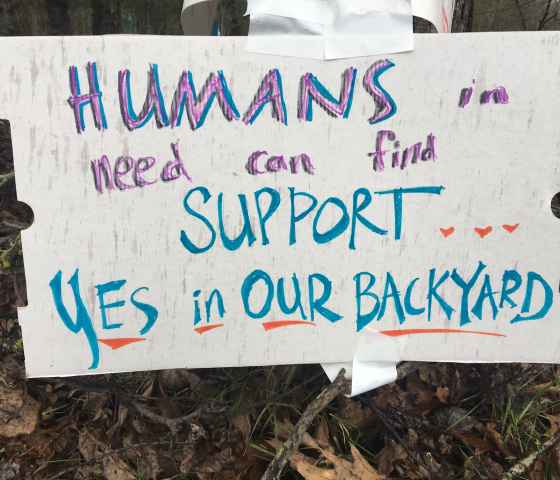 sign reads: Humans in need can find support...yes, in our backyard